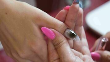 From above of crop unrecognizable manicurist doing nail art for female client in beauty salon video