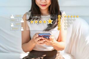 Young woman traveler using smartphone to give a five-star satisfaction rating of the food and drinks at restaurant on social media, Travel lifestyle concept photo