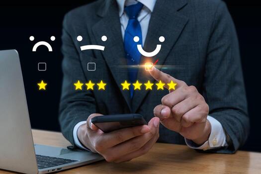 Feedback. business man using mobile phone and laptop computer with five star button to review good rating, satisfaction, customer review, digital marketing, good experience, product review concept photo