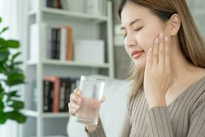 Asian woman feel sensitive teeth after drinking cold, female suffer tooth, decay problems, dental care, tooth extraction, decay problem, bad breath, Gingival Recession, Oral Hygiene instruction photo
