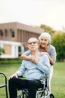 Asian senior couple having a good time. They laughing and smiling while sitting outdoor at the park. Lovely senior couple photo