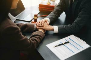 Judge gavel with scales of justice, Business and lawyer or counselor consulting and discussing contract papers with laptop and tablet at law firm in office. photo