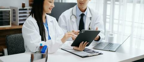 Medical technology network team meeting concept. Doctor hand working with smart phone modern digital tablet and laptop computer with graphics chart interface, with virtual icon diagram photo