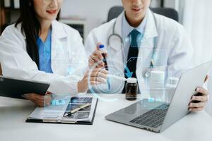 Medical technology network team meeting concept. Doctor hand working with smart phone modern digital tablet and laptop computer with graphics chart interface, with virtual icon diagram photo