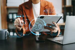 Woman using chatbot in computer and tablet  smart intelligence Ai.Chat with AI Artificial Intelligence, developed by OpenAI generate. Futuristic technology, robot in online system. photo