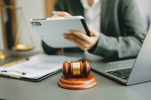 Male lawyer in the office with brass scale on wooden table. justice and law concept in morning light photo