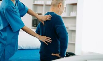Doctor consulting with patient Back problems Physical therapy concept photo