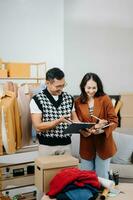 Diverse female fashion designers at work with tailor centimeters on necks and holds tablet and smartphone. independent creative design business. photo