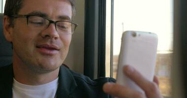 Man having a video chat on mobile during train ride