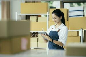 Happy entrepreneurs using tablets for check order and Checking stock for delivering products to customers. photo