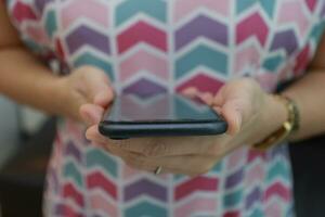 Smartphone in hand with blur background photo