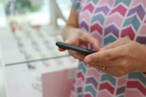 Using phone, holding smartphone, mobile phone in hand photo