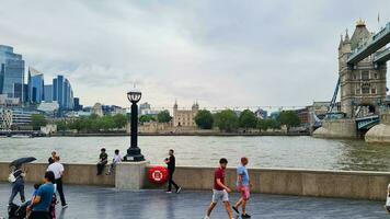 Low Angle View of World Famous Tourist Attraction at Tower Bridge and River Thames Which is Mostly Crowded with International Tourists at Central London, England UK. Captured on June, 18th 2023 photo