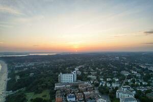 Aerial View of British Tourist Attraction of Bournemouth Beach and Sea view City of England Great Britain UK. Image Captured with Drone's Camera on September 9th, 2023 During Sunset photo