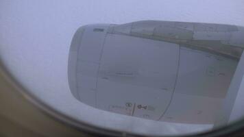 Looking at engine and clouds from inside flying plane video