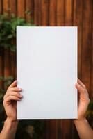 Content marketing. Hands holding a white empty paper photo