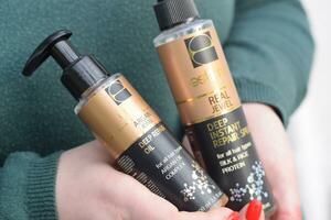 Young girl holds Estima products. Estima argan jewel deep repair oil and real jewel deep instant repair spray photo