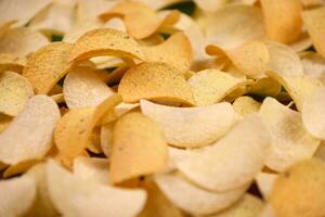 Many orange Pringles potato snack chips. Pringles is a brand of potato snack chips owned by Kellogg Company photo