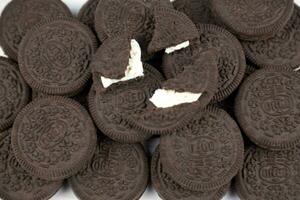 Oreo sandwich cookies on white table. Oreo is a sandwich cookie with a sweet cream is the best selling cookie in the US photo