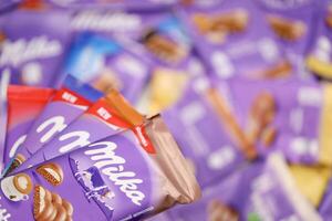 KHARKOV, UKRAINE - DECEMBER 8, 2020 Many wrappings of purple Milka chocolate. Milka is a Swiss brand of chocolate confection manufactured by company Mondelez International photo