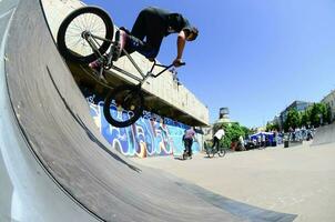 kharkiv, ucrania - 27 de mayo de 2018 ciclistas de bmx freestyle en un skatepark durante el festival anual de culturas callejeras foto