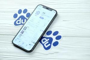 KHARKOV, UKRAINE - MARCH 5, 2021 Baidu icon and application from App store on iPhone 12 pro display screen on white table photo