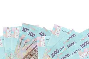 1000 Ukrainian hryvnias bills lies on bottom side of screen isolated on white background with copy space. Background banner template photo