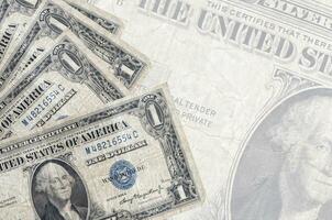 1 US dollar bills lies in stack on background of big semi-transparent banknote. Abstract business background photo