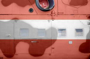 Austria flag depicted on side part of military armored helicopter closeup. Army forces aircraft conceptual background photo