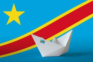 Democratic Republic of the Congo flag depicted on paper origami ship closeup. Handmade arts concept photo