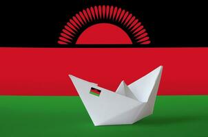 Malawi flag depicted on paper origami ship closeup. Handmade arts concept photo