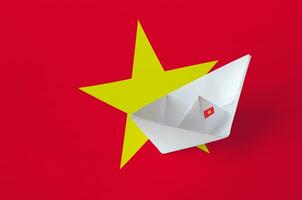 Vietnam flag depicted on paper origami ship closeup. Handmade arts concept photo