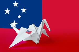 Samoa flag depicted on paper origami crane wing. Handmade arts concept photo