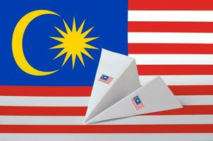 Malaysia flag depicted on paper origami airplane. Handmade arts concept photo