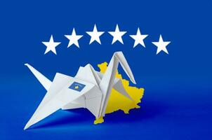 Kosovo flag depicted on paper origami crane wing. Handmade arts concept photo