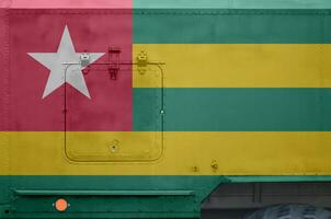 Togo flag depicted on side part of military armored truck closeup. Army forces conceptual background photo