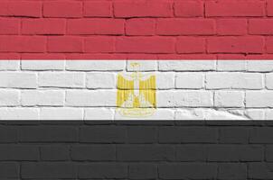 Egypt flag depicted in paint colors on old brick wall. Textured banner on big brick wall masonry background photo