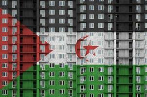 Western Sahara flag depicted in paint colors on multi-storey residental building under construction. Textured banner on brick wall background photo