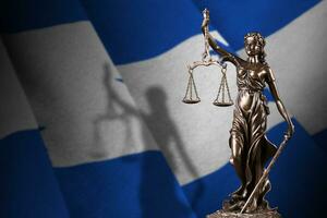 Honduras flag with statue of lady justice and judicial scales in dark room. Concept of judgement and punishment photo