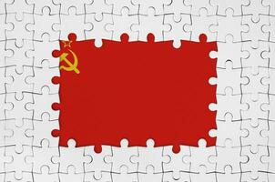 Soviet Union flag in frame of white puzzle pieces with missing central part photo