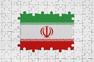Iran flag in frame of white puzzle pieces with missing central part photo
