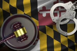 Maryland US state flag with judge mallet and handcuffs in dark room. Concept of criminal and punishment photo