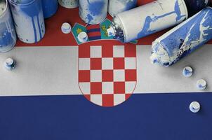 Croatia flag and few used aerosol spray cans for graffiti painting. Street art culture concept photo