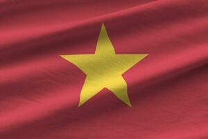 Vietnam flag with big folds waving close up under the studio light indoors. The official symbols and colors in banner photo