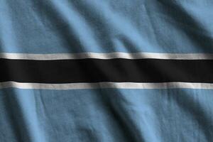 Botswana flag with big folds waving close up under the studio light indoors. The official symbols and colors in banner photo