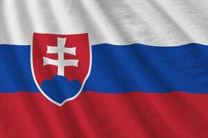 Slovakia flag with big folds waving close up under the studio light indoors. The official symbols and colors in banner photo