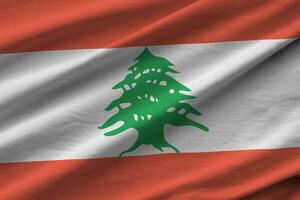 Lebanon flag with big folds waving close up under the studio light indoors. The official symbols and colors in banner photo