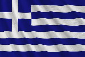 Greece flag with big folds waving close up under the studio light indoors. The official symbols and colors in banner photo