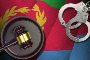 Eritrea flag with judge mallet and handcuffs in dark room. Concept of criminal and punishment, background for judgement topics photo