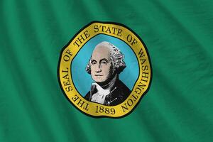 Washington US state flag with big folds waving close up under the studio light indoors. The official symbols and colors in banner photo